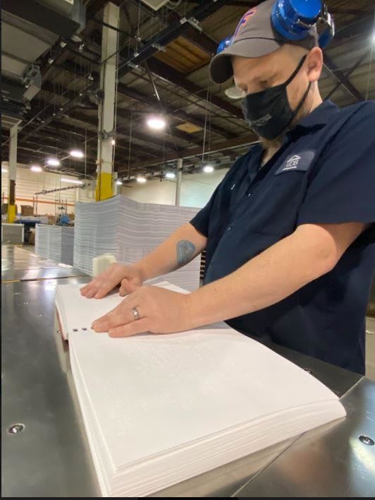 AIB worker using braille